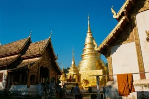 Golden temple spires in Chiang Mai against a clear sky
